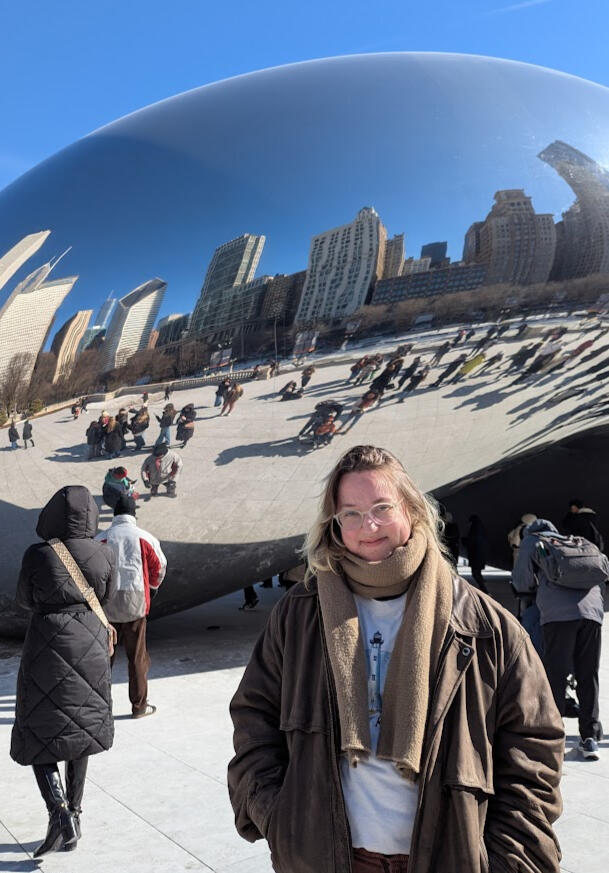 August Helpling standing in front of Cloud Gate, also known as the Chicago Bean.